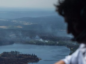 A regional government in British Columbia's southern Interior is mulling more than 70 recommendations to improve its response to wildfires, less than a year after devastating blazes charred thousands of square kilometres of timber and bush within its boundaries. Prime Minister Justin Trudeau views areas affected by wildfire during an aerial tour in a Canadian Forces Chinook helicopter near Williams Lake, B.C., on Monday, July 31, 2017.