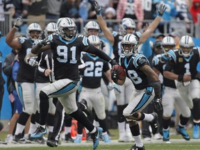 Carolina Panthers' Damiere Byrd (18) returns a kickoff for a touchdown against the Tampa Bay Buccaneers during the first half of an NFL football game in Charlotte, N.C., on December 24, 2017. Carolina Panthers' Bryan Cox Jr
