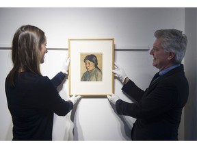 Lauren Kratzer and Robert Heffel House display an Emily Carr portrait of her friend Sophie Frank.