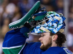 Vancouver Canucks' goalie Thatcher Demko puts on his helmet during first period NHL hockey action against the Columbus Blue Jackets at Rogers Arena on Saturday afternoon.