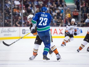 Alexander Edler, who had a strong game, unloads on Rickard Rakell at Rogers Arena.