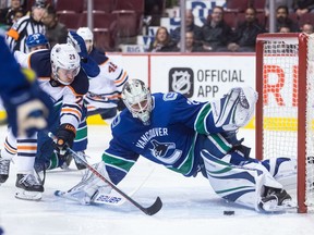 Edmonton Oilers centre Leon Draisaitl (29) of Germany, is stopped by Vancouver Canucks goaltender Jacob Markstrom (25), of Sweden, during the first period of an NHL hockey game in Vancouver, B.C., on Thursday March 29, 2018.