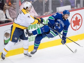 Filip Forsberg and Alex Edler go bump in the night Friday.