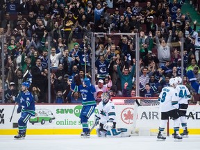 Vancouver Canucks' Reid Boucher, left, and Jake Virtanen, second left, celebrate Nikolay Goldobin's goal against San Jose Sharks' goalie Aaron Dell, centre, as Joe Pavelski (8) and Marc-Edouard Vlasic (44) look on during the first period of an NHL hockey game in Vancouver, B.C., on Saturday March 17, 2018.