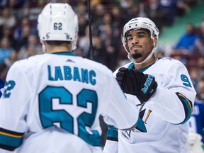 San Jose Sharks' Evander Kane, back right, and Kevin Labanc celebrate Labanc's goal against the Vancouver Canucks during the first period of an NHL hockey game in Vancouver, B.C., on Saturday March 17, 2018.