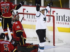 San Jose Sharks left wing Evander Kane (9) celebrates his fourth goal as Calgary Flames goaltender Mike Smith (41) looks away during third period NHL hockey action in Calgary, Friday, March 16, 2018.