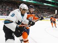 San Jose Sharks left-winger Evander Kane (left) and Edmonton Oilers centre Connor McDavid battle along the boards during their NHL game in Edmonton on Wednesday. (Photo: Jason Franson, Canadian Press)