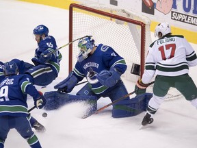 Minnesota Wild left wing Marcus Foligno (17) fails to get a shot past Vancouver Canucks goaltender Anders Nilsson (31) as left wing Brendan Leipsic (9), centre Bo Horvat (53) and defenceman Alex Biega (55) look on during first period NHL action in Vancouver, Friday, March, 9, 2018.