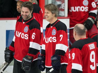 Darryl James (6) and Jim Cuddy (7) share a laugh during the Juno Cup hockey game in Burnaby, B.C., on Friday March 23, 2018.