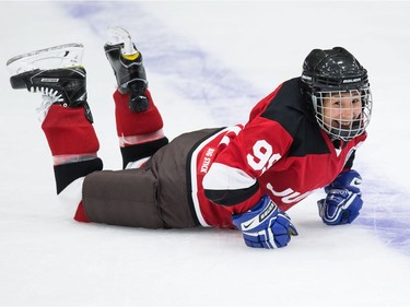 Nancy Mike of The Jerry Cans picks herself up after falling during the Juno Cup hockey game in Burnaby on Friday.