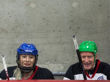 Bobsleigh athlete Kaillie Humphries, left, and former Edmonton Oilers winger Brian "BJ" MacDonald sit on the bench during the Juno Cup.