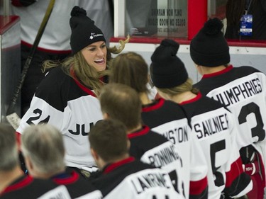 Team NHL and Olympians' Natalie Spooner greets her teammates as she steps onto the ice to play the Rockers in the 15th annual Juno Cup hockey game at the Bill Copeland Sports Centre in Burnaby.
