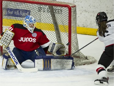 Team Rockers goalie Danielle Dube reaches for a shot from Team NHL and Olympians Rebecca Johnston during the skills portion of the 15th annual Juno Cup hockey game at the Bill Copeland Sports Centre in Burnaby.