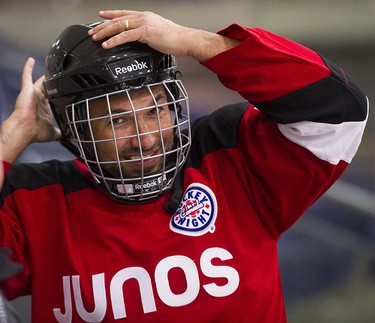 Musician Victor Micallef (of The Tenors) smiles as Juno Cup players take to the ice for a practice at the Bill Copeland Sports Centre in Burnaby on March 22, 2018.