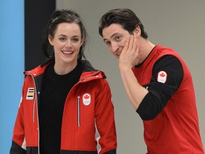 Scott Moir and Tessa Virtue arrive at the airport in London, Ont., on Feb. 26, 2018.
