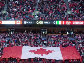 A large Canadian flag is held up by fans before Canada and Mexico play a FIFA World Cup qualifying soccer match in Vancouver, B.C., on Friday March 25, 2016.
Vancouver is out of the running for the 2026 World Cup after the province failed to reach a deal with the North American bid committee.