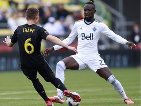 Columbus Crew midfielder Wil Trapp (6) looks for a way around Vancouver Whitecaps forward Kei Kamara (23) in the first half of an MLS soccer game in Columbus, Ohio, Saturday.