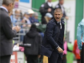 Vancouver Whitecaps head coach Carl Robinson, center, reacts to a play from the sideline during the first half of an MLS soccer match against the Seattle Sounders, Saturday, Sept. 17, 2016, in Seattle.