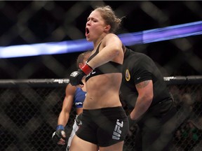 Ronda Rousey celebrates defeating Liz Carmouche after their UFC 157 women's bantamweight championship mixed martial arts match in Anaheim, Calif., Saturday, Feb. 23, 2013.