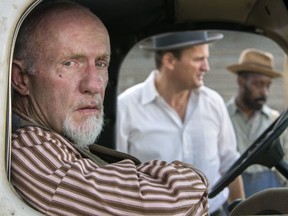 This image released by Netflix shows Jonathan Banks, from left, Jason Clarke and Rob Morgan in a scene from "Mudbound." (Steve Dietl/Netflix via AP)