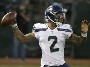 FILE - In this Aug. 31, 2017, file photo, Seattle Seahawks quarterback Trevone Boykin (2) passes against the Oakland Raiders during the first half of an NFL preseason football game in Oakland, Calif. The Seattle Seahawks released quarterback Trevone Boykin shortly after his girlfriend alleged in a television interview that he physically assaulted her in Texas. The practice squad player was released from the team Tuesday, March 27, 2018, after WFAA-TV in Dallas posted an interview with Boykin's girlfriend. She alleges he broke her jaw during an altercation last week in Mansfield, southwest of Dallas. Boykin's agent, Drew Pittman, told the station the allegations are false. Mansfield police told WFAA that Boykin is under investigation.