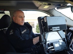 Delta police Const. Michael Whiteley demonstrates the new electronic traffic violation tickets (eTicket) equipment, which will be used as part of a pilot program designed to make roads safer.