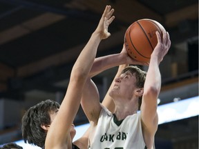 Oak Bay Bays' Riley Cronk tries to shoot over Burnaby South Rebels Sasha Vujisic during the quarterfinals of the quad-A, B.C. high-school boys' championship at the Langley Events Centre on March 8.