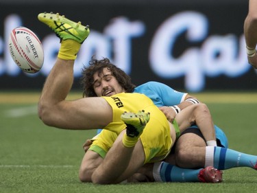 Manual Ardao of Uruguay tackles Charlie Taylor of Australia during the World Rugby Seven Series at B.C. Place in Vancouver, Saturday, March, 10, 2018.