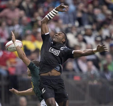 Joe Ravouvou of New Zealand, right, fights for control of the ball with Muller du Plessis of South Africa during the World Rugby Seven Series at B.C. Place in Vancouver, Saturday, March, 10, 2018.