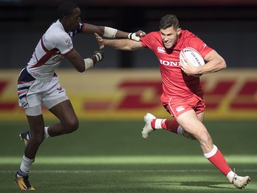 Justin Douglas of Canada tries to outrun Perry Baker of the United States during the World Rugby Seven Series at B.C. Place in Vancouver, Saturday, March, 10, 2018.