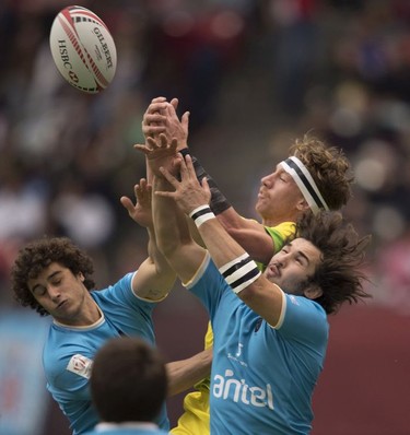 Uruguay tries to take control of the ball from Australia during the World Rugby Seven Series at B.C. Place in Vancouver, Saturday, March, 10, 2018.