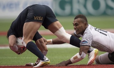 Eroni Sau of Fiji, right, tackles Luciano Gonzalez of Argentina during the World Rugby Seven Series at B.C. Place in Vancouver, Sunday, March, 11, 2018.