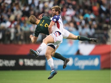 United States' Nick Boyer, front, and South Africa's Dylan Sage collide during World Rugby Sevens Series bronze medal game action, in Vancouver, B.C., on Sunday March 11, 2018.