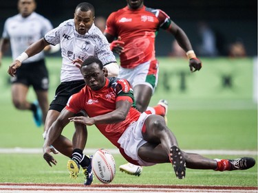 Kenya's Billy Odhiambo, front, and Fiji's Alasio Sovita vie for the ball during World Rugby Sevens Series final action, in Vancouver, B.C., on Sunday March 11, 2018.