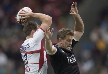 Scott Curry of New Zealand, right, tries to block Ben Pinkelman of the United States during the World Rugby Seven Series at B.C. Place in Vancouver, Sunday, March, 11, 2018.