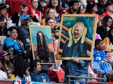 Spectators dressed as paintings watch Australia and Argentina play during World Rugby Sevens Series action, in Vancouver, B.C., on Sunday March 11, 2018.