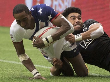Ngarohi McGarvey-Black of New Zealand tackles Perry Baker of the United States during a match at the World Rugby Seven Series at B.C. Place in Vancouver, Sunday, March, 11, 2018.