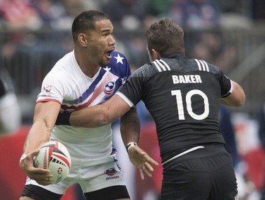 Kurt Baker of New Zealand, right, tries to stop Kevon Williams of the United States during the World Rugby Seven Series at B.C. Place in Vancouver, Sunday, March, 11, 2018.