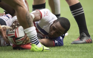 Perry Baker of the United States tries to pass the ball to a teammate during a match against New Zealand during the World Rugby Seven Series at B.C. Place in Vancouver, Sunday, March, 11, 2018.
