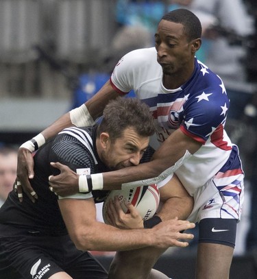 Perry Baker of the United States, right, tackles Kurt Baker of New Zealand during the World Rugby Seven Series at B.C. Place in Vancouver, Sunday, March, 11, 2018.