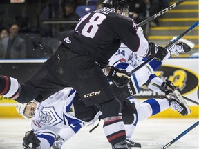 VICTORIA, B.C.: MARCH 23, 2018-Vancouver Giants Darian Skeoch takes out  Victoria Royals Dino Kambeitz in WHL playoff action at the Save-on-Foods Memorial Centre   in Victoria, B.C. March  23, 2018.  Skeoch  received a major penalty and a game misconduct for the hit.