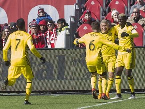 Columbus Crew's Gyasi Zerdes (right) celebrates with Cristian Martinez and Will Trapp (6) after scoring his team's second goal against Toronto FC during second half MLS action in Toronto on Saturday, March 3, 2018.