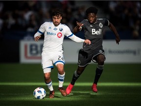 Montreal Impact's Michael Petrasso, left, and the Whitecaps' Alphonso Davies vie for the ball during an MLS game in Vancouver on March 4.
