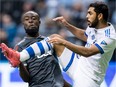 Whitecaps' Kei Kamara, left, and Montreal Impact's Victor Cabrera collide during the second half of an MLS game in Vancouver on March 4.