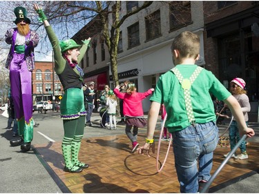 Ariel Amara ( C ) leads a hulu hoop session at the St. Patrick's Day party at the Blarney Stone, Vancouver, March 17 2018.