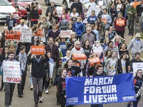 People march during a "March For Our Lives" rally in Oxford, Miss., Saturday, March 24, 2018. Students and activists across the country planned events Saturday in conjunction with a Washington march spearheaded by teens from Marjory Stoneman Douglas High School in Parkland, Fla., where over a dozen people were killed in February.