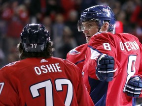 Washington Capitals left wing Alex Ovechkin (8) reaches to celebrate with right wing T.J. Oshie (77) after scoring in the first period of an NHL hockey game against the Winnipeg Jets, Monday, March 12, 2018, in Washington.