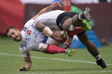 Eroni Sau of Fiji (right) tackles Pierre Sayerse of France during the World Rugby Seven Series at B.C. Place in Vancouver, Saturday, March, 10, 2018.