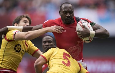 Daniel Sikuta of Kenya is chased by Pablo Fontes (left) and Manuel Sainz of Spain during the World Rugby Seven Series at B.C. Place in Vancouver, Saturday, March 10, 2018.