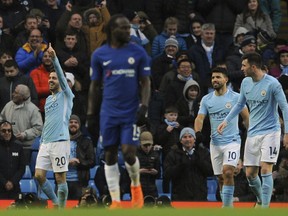 Manchester City's Bernardo Silva, left, celebrates after scoring his side's opening goal during the English Premier League soccer match between Manchester City and Chelsea at the Etihad Stadium in Manchester, England, Sunday, March 4, 2018.
